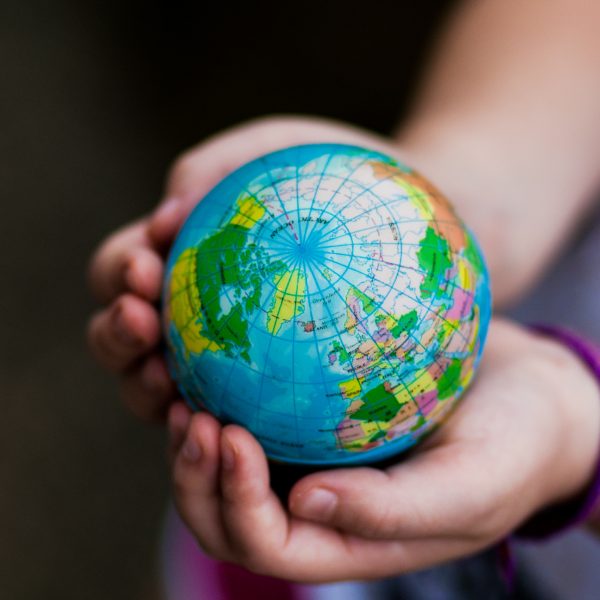 Little girl holding the earth in her hands. Earth day. Green concept Little girl holding the earth in her hands. Earth day. Green concept